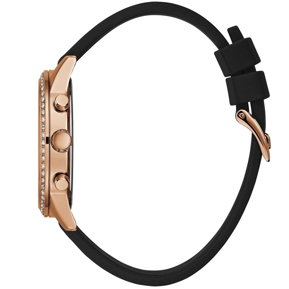 ساعة يد نسائية Guess Solar Multi-Function W1135L4، بهيكل ذهبي وردي، وإطار كريستالي، ومينا أسود، وسوار مطاطي أسود.