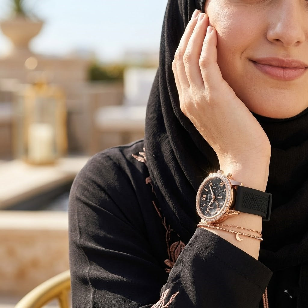 ساعة يد نسائية Guess Solar Multi-Function W1135L4، بهيكل ذهبي وردي، وإطار كريستالي، ومينا أسود، وسوار مطاطي أسود.