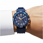 ساعة رجالي من Guess Commander GW0211G4 بحزام مطاطي وإطار أزرق وهيكل ذهبي وردي