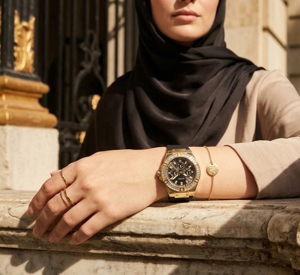 ساعة نسائية من Guess Venus GW0118L1 بمينا أسود وحزام مطاطي أسود بإطار ذهبي